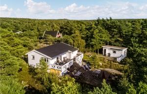 an aerial view of a house in the woods at 4 Bedroom Stunning Home In Gressvik in Gressvik