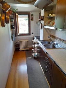 a small kitchen with a sink and a window at Attico Vittoria in Rivisondoli