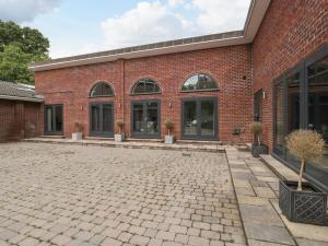 a brick building with windows and a courtyard at The Annex in Wimborne Minster