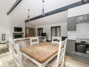 a kitchen and dining room with a wooden table at The Annex in Wimborne Minster