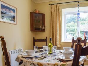 a dining room with a table and a window at Bear Cottage in Abbey Dore