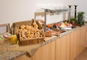 a buffet with bread and other foods on a counter at Hotel Apart Garni Heisenhof in Westendorf