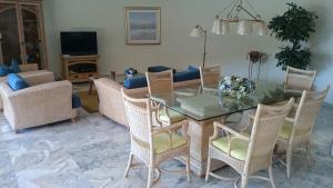 a living room with a glass table and chairs at Villa Luxe Tauro Mogan in Puerto Rico de Gran Canaria