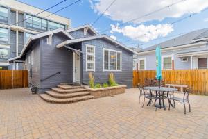 a gray house with a table and chairs and a patio at Stylish 2-Bedroom walking distance to Downtown in Reno