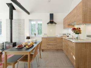 a kitchen with a table with a bowl of fruit on it at The Old Meeting Hall in Kings Somborne