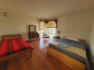 a bedroom with a bed and a mirror and a chair at Hermosa casona sobre la represa la Esmeralda in Somondoco