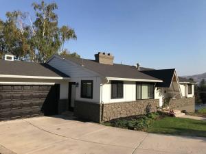 a white house with a fence and a driveway at City light views getaway close to top ski resorts in Salt Lake City