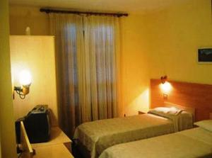 Postel nebo postele na pokoji v ubytování Hotel Quo Vadis