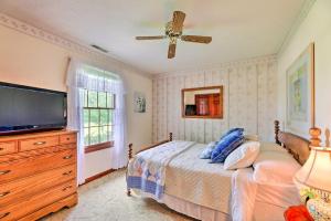 a bedroom with a bed and a flat screen tv at Charming Williamstown Retreat with Private Yard in Williamstown