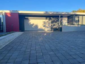 a building with a garage with a brick driveway at Die Vlei in Port Elizabeth