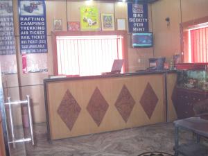 a ticket counter in a restaurant with a laptop on it at Hotel Shiv Ganga in Rishīkesh