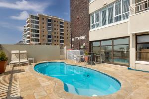 a swimming pool on the roof of a building at First floor with beautiful sea view in Cape Town