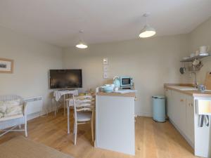 a kitchen with a counter and a table in a room at Mortimer Trail Mews in Aymestrey