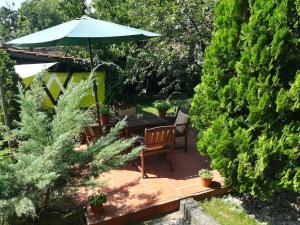 a patio with a table and an umbrella at Gray apartment in Čukarica