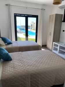 Postel nebo postele na pokoji v ubytování Riviera Vichayito