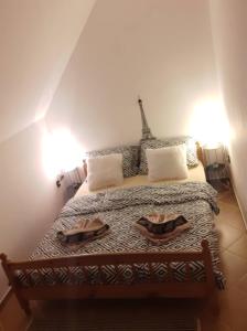 a bedroom with a bed with two plates on it at Erdey Apartman in Barcs