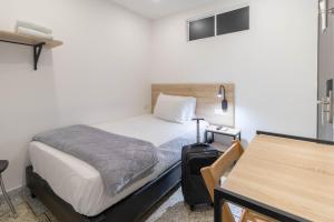 a small bedroom with a bed and a suitcase at Bianco Hotel Boutique in Cúcuta +77 photos