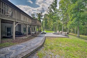 ein Haus mit einer Terrasse neben einem Hof in der Unterkunft Family-Friendly Cassville Retreat with Deck! 