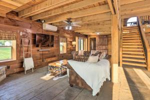a log cabin with a bed and a living room at Charming Jeffersonville Barndominium with Fire Pit! in Jeffersonville