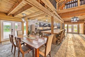 a dining room with a table and a kitchen at Charming Jeffersonville Barndominium with Fire Pit! in Jeffersonville