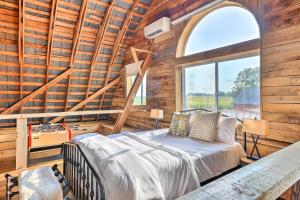a bedroom with a bed and a large window at Charming Jeffersonville Barndominium with Fire Pit! in Jeffersonville