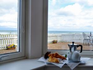 a kitchen window with a view of the ocean at Seascape in Whitehills