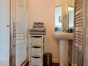 a bathroom with a sink and a mirror and towels at Seascape in Whitehills