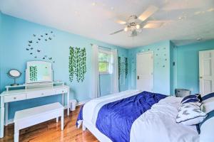 a blue bedroom with a bed and a desk at Family-Friendly Brookville Home with Hot Tub! in Brookville