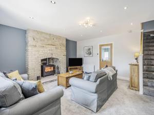 a living room with two couches and a fireplace at Emmaville in Ryton