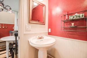 a bathroom with a white sink and a red wall at Brittany Place Condo - Great Downtown Location - On Main St in Breckenridge +20 photos