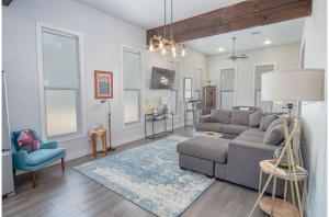 a living room with a gray couch and a blue chair at Gorgeous Family-Friendly Home Near Downtown in San Antonio