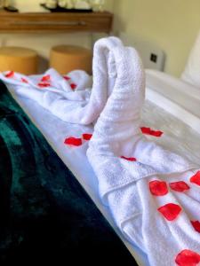 a couple of white towels with red hearts on a bed at MeeZee Pearl Double Bed Lodge With Free Parking in Manchester