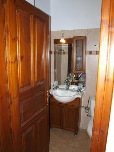 a bathroom with a sink and a toilet and a door at Heliodora in Kissós