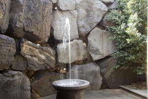 a water fountain in front of a stone wall at Villa Remedios in Teguise