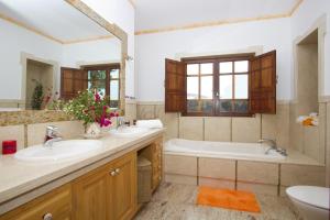 a bathroom with two sinks and a tub at Villa Remedios in Teguise +19 photos