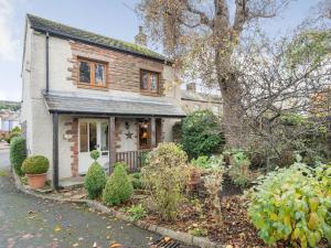 an old house with a garden in front of it at The Cowshed in Penrith