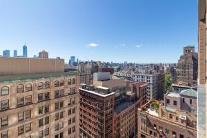 an aerial view of a city with tall buildings at LUXURY DESIGNER GREENWICH VILLAGE 1BR HEAVEN!! BEAUTIFUL PANORAMIC CITY VIEWS! in New York