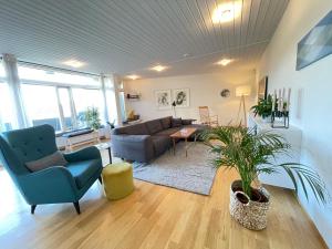 a living room with a couch and a table at Cosy and spacious apartment in Reykjavik in Reykjavík