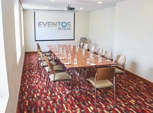 a conference room with a long table and chairs at Hotel Estelar San Isidro in Lima