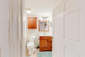 a bathroom with a toilet and a sink and a mirror at Moody Creek Cabin in Seven Devils +30 photos