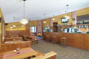 a restaurant with a bar and tables and chairs at La Pinetina in San Massimo
