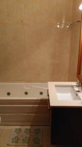a bathroom with a sink and a bath tub and a sink at Casa campo ermal in Braga