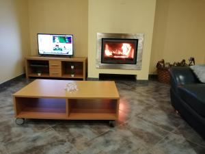 a living room with a coffee table and a fireplace at Casa campo ermal in Braga