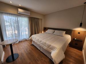 a hotel room with a bed and a large window at Clayton Buenos Aires in Buenos Aires