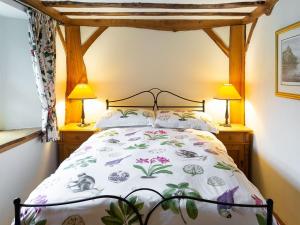 a bedroom with a bed with a canopy at Fochy Cottage in Milnathort