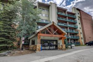 an apartment building with a large glass door at Trails End Mountain Breeze Condo - Ski In - Out - Stroll To Main Street in Breckenridge