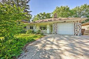 a house with a garage and a driveway at Riverfront Retreat about 4 Mi to Downtown Milwaukee! in Glendale