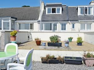 a house with a patio with potted plants at Seascape in Balintore