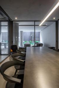 a conference room with a long table and chairs at Noon Vila Madalena in Sao Paulo