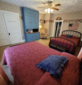 a bedroom with two beds and a ceiling fan at Prairie House Manor Bed and Breakfast in De Smet